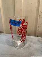Full view of the vintage Pepsi-Cola glass showing red logo and clear body