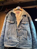 Full front view of Lee Storm Rider denim jacket on hanger