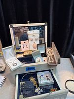 Overall view of open jewelry box showing contents and interior compartments