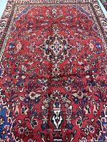 Full view of red Hamadan rug showing central medallion and overall floral pattern