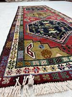 Full length perspective of runner showing fringe, borders, and field design