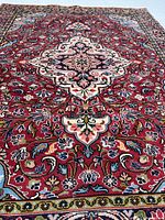 Full rug showing central medallion and red field