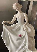 Front view of Royal Doulton Tracy figurine showing gown and flower