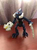 Front view of Bionicle figure with both accessories attached