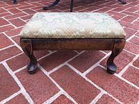 Foot stool front view showing cabriole legs and upholstered top