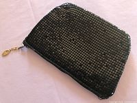 Full view of black sequin mesh clutch front