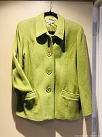 Front view of bright green blazer on hanger