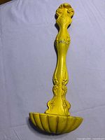 Full view of yellow cast iron ladle