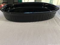 Side view of black oval casserole dish