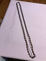 Entire length of 2-strand necklace laid flat on table