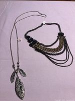 Both necklaces laid out to show full length and design