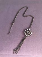 Full view of necklace showing chain, pendant, tassel