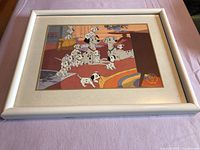 Front view of framed Disney Dalmatian litho on lavender background