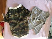 Camouflage shirt and gray undershirt laid flat