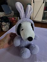 Full front view of Snoopy plush in bunny suit