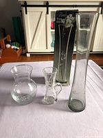 Three etched glass vases with original box visible