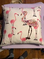Front view of square pillow showing flamingo print and textured applique