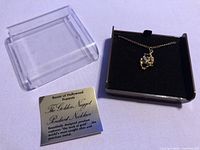 Necklace in box with lid and product card