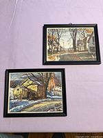 Both framed prints on table