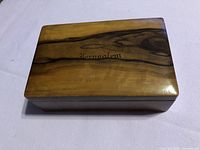 Top view of wood trinket box showing grain and Jerusalem inscription