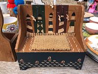 Front view of painted wood bench showing lighthouse scene and jute seat