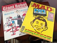 Mad Magazine and Giant Robot magazine on surface
