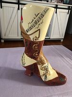 Full view of boot-shaped ceramic vase