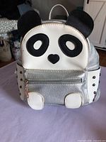 Front view showing panda face, front pocket, overall design
