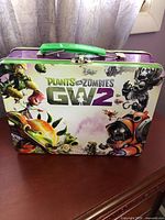 Front view of Plants vs Zombies GW2 metal lunchbox