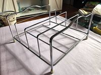 Overall view of chrome album holder showing compartments and handles