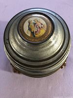 Top view showing lid portrait and metal finish