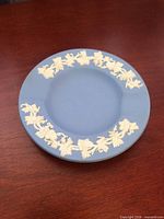 Top view showing blue Jasperware ashtray with white grapevine relief