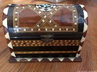 Front view showing geometric inlay pattern, latch, size reference