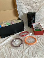 All items: open filament box, pen packaging, three sealed filament coils