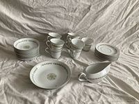 entire lot overview showing gravy boat, stacks of plates and cups