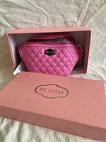 Waist bag inside original pink Bloom box showing quilted front and logo plate