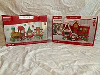 Front of both boxed kits showing artwork, piece counts and branding