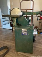 Front view of Craftex combination sander on stand showing disc, table, label