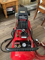Top view of Craftsman compressor showing control panel, gauges, and hose connections