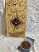 Front view of folded Marauder's Map with bag tag in packaging