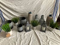 All items arranged together: vases, planters, lanterns, faux plants
