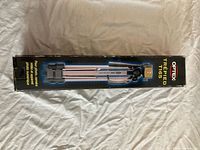 Front of sealed Optex T165 tripod retail box
