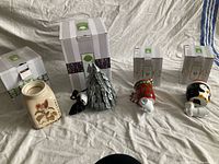Group view of four Scentsy wax warmers with their boxes