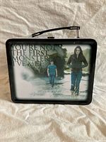Front of lunch box showing Bella and Edward image and quote