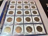 Full binder page showing twenty 1980 Olympic Trust tokens in flips