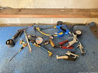 Group view of all air compressor accessories spread on blue surface