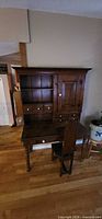 Full view of pine secretary desk with hutch and chair