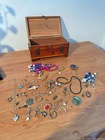Overall view of jewelry pieces scattered in front of wooden box
