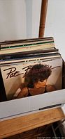 Box of vinyl records showing Pat Benatar album on top