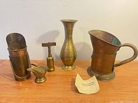 Group shot of all five brass and copper items